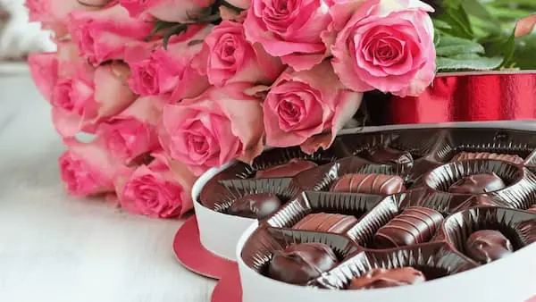 How are Valentine's Day Gifts Freight Shipped a bouquet of pink roses next to a heart shaped box of chocolates