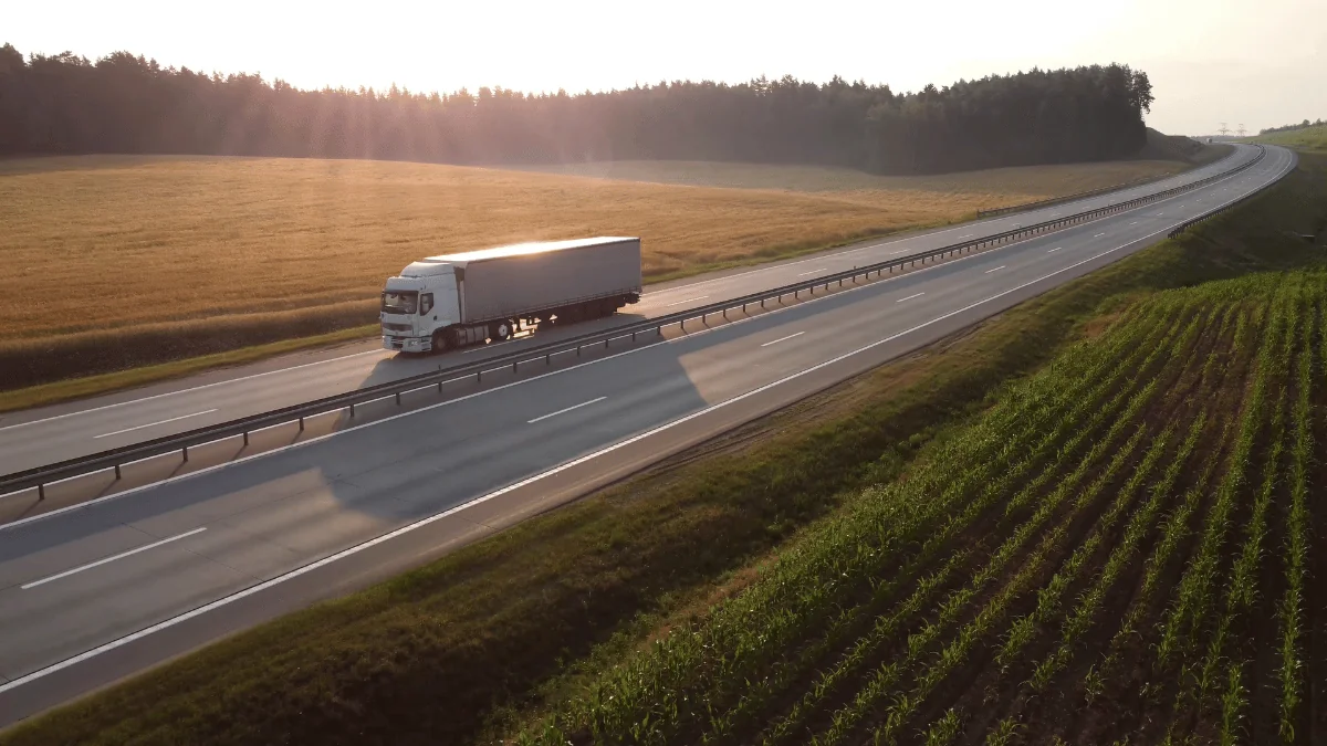 Self-Driving Vehicles semi truck driving down highway in the countryside in the afternoon