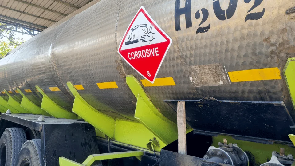 Shipping Chemicals and Hazardous Materials metal H2O2 tanker with corrosive sign