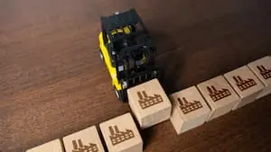 How to Diversify Your Supply Chain toy forklift lifting a wooden block with a factory symbol on it alongside other wooden blocks with the same symbol BLOG PREVIEW VERSION