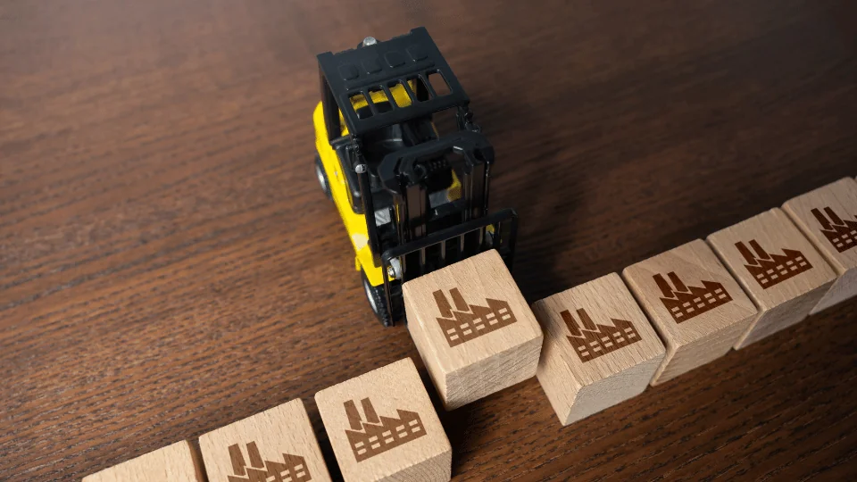 How to Diversify Your Supply Chain toy forklift lifting a wooden block with a factory symbol on it alongside other wooden blocks with the same symbol