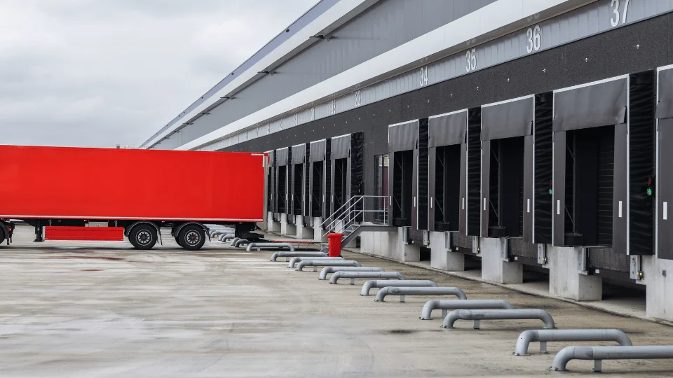 red trailer waiting to be loaded at distribution center