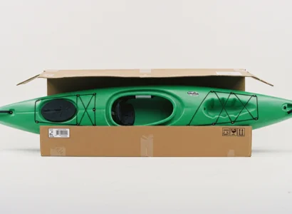 green kayak partially covered in cardboard