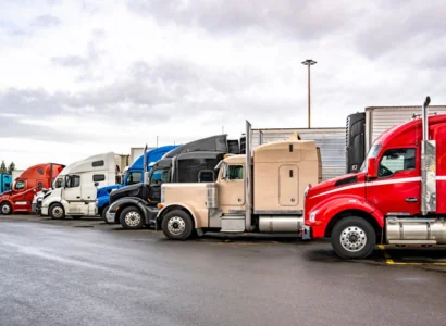 multiple parked semi trailer trucks