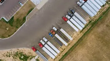Top Truck Stops to Visit While on the Road top-down view of semi trucks parked at a truck stop PREVIEW VERSION